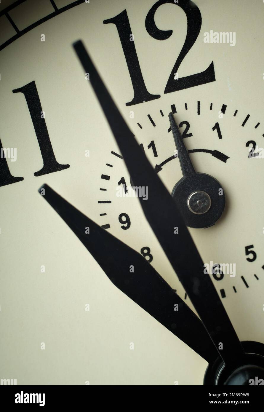 Clock face closeup at alarm time (Twelve o`clock Stock Photo Alamy